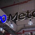 The Meta Lawsuit Every American Worker Should Pay Attention To Meta logo sign hanging at a trade show booth