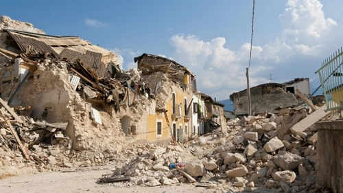 shutterstock_2259963673 Rubble from collapsed buildings in earthquake-hit area. Clear sky.