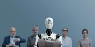 Robot holding a briefcase sits among human job candidates