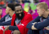 Basketball players on the bench sharing a laugh