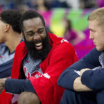 Basketball players on the bench sharing a laugh