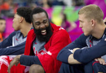 A Freak Fall Just Changed England’s World Cup Basketball players on the bench sharing a laugh