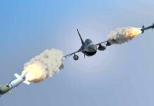 fighter jet firing two missiles in flight