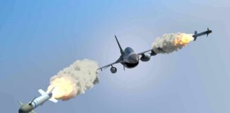 fighter jet firing two missiles in flight