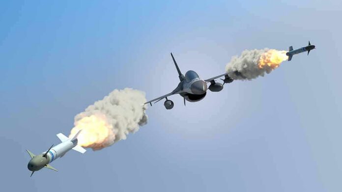 shutterstock_317815559 fighter jet firing two missiles in flight