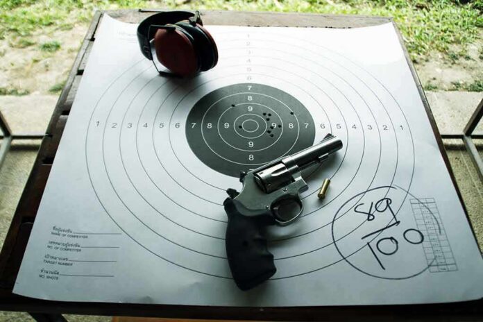 shutterstock_623754059 Revolver and ear protection on paper shooting target