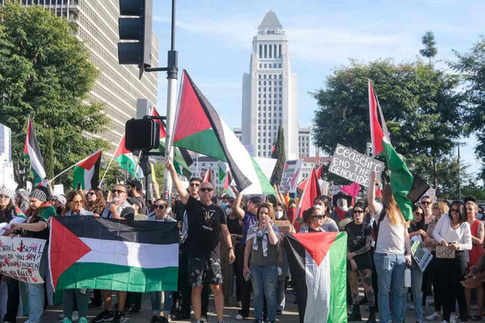 Protesters holding signs and flags in a public square.