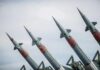 Four angled military missiles on launchers