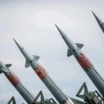 Four angled military missiles on launchers