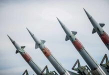 Four angled military missiles on launchers