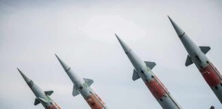 Four angled military missiles on launchers