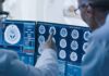 Doctors reviewing brain MRI scans on multiple monitors