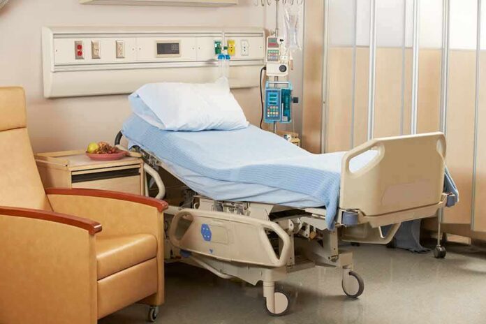 shutterstock_125077214 Hospital bed with blue linens in a patient room