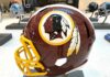maroon football helmet with yellow facemask on display