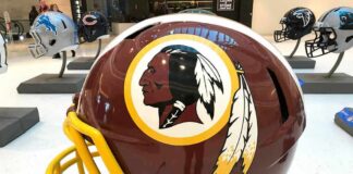 maroon football helmet with yellow facemask on display