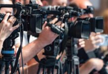 television cameras on tripods at a media event