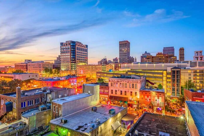City skyline at dusk with lit streets and buildings