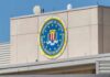 FBI emblem on a beige building facade