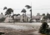 Houses battered by hurricane winds and flooding