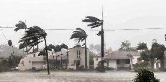 Houses battered by hurricane winds and flooding