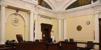 empty courtroom with judge's bench and columns