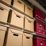 Shelves filled with brown and red storage boxes for organizing documents