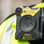Body-worn camera attached to a high-visibility vest