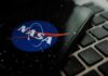 NASA logo on smartphone resting on a laptop keyboard