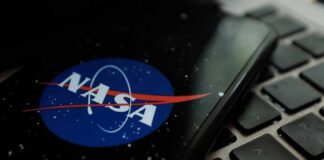 NASA logo on smartphone resting on a laptop keyboard