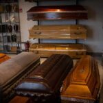 Row of coffins displayed in a funeral home showroom