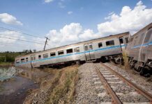 A Russian Drone Hit A Train Carrying 206 People An overturned train on a railway track surrounded by vegetation