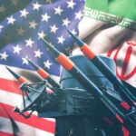 Missile launchers in front of U.S. and Iranian flags