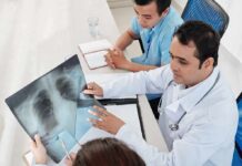 Doctors reviewing a chest X-ray at a desk