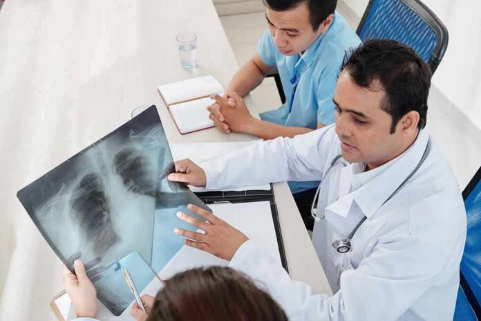 Doctors reviewing a chest X-ray at a desk