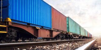 Freight train with colorful shipping containers on railway tracks