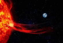 Sun with solar flare extending toward Earth in space