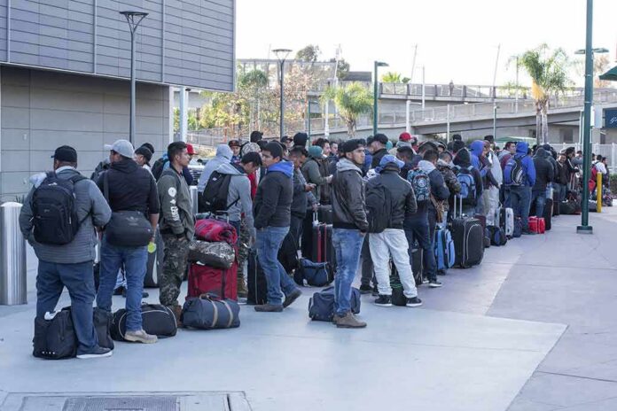 Fernando Salas and a large group of travelers waiting in a long line with luggage