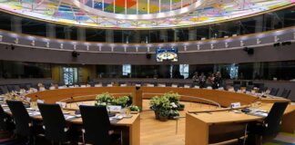 Conference room with circular table and microphones