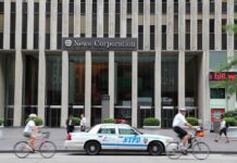 News Corporation building entrance with NYPD car and cyclists