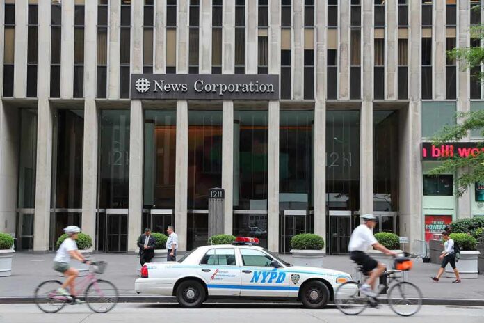 News Corporation building entrance with NYPD car and cyclists