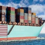 Cargo ship bow loaded with stacked containers at sea