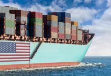 Cargo ship bow loaded with stacked containers at sea
