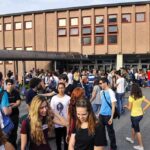 Locker Room Bombshell: Coach Arrested Fast Students gathered outside a school building entrance