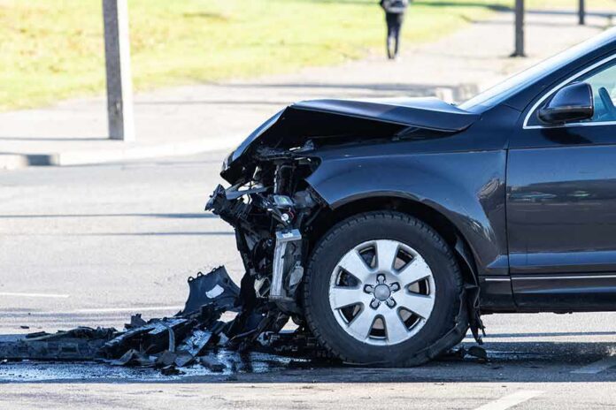 shutterstock_1929744857 Damaged car with crushed front end after collision