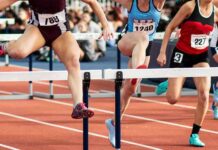 2,293 Women’s Gold Medals Spark New Fight Female athletes clearing hurdles on a track