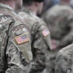 Soldiers in camouflage uniforms with U.S. flag patches