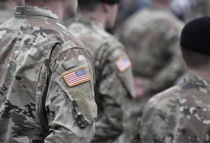Soldiers in camouflage uniforms with U.S. flag patches