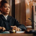 Judge seated at bench holding a gavel
