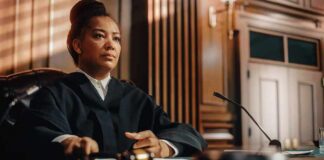 Judge seated at bench holding a gavel