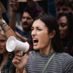 No Papers Needed for Power Woman with megaphone shouting at a protest